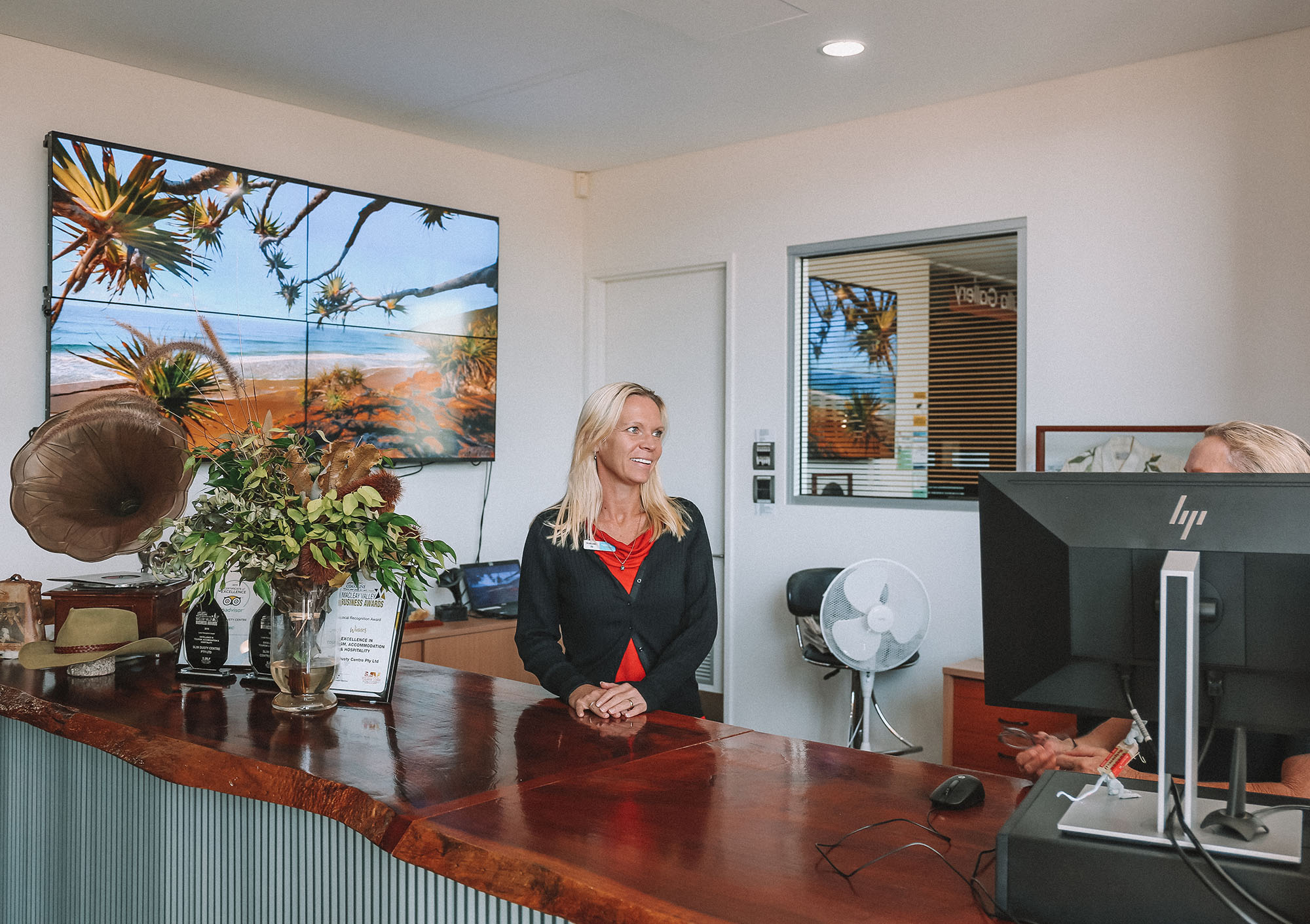 Customer experience officer standing at front desk at the Slim Dusty Centre.