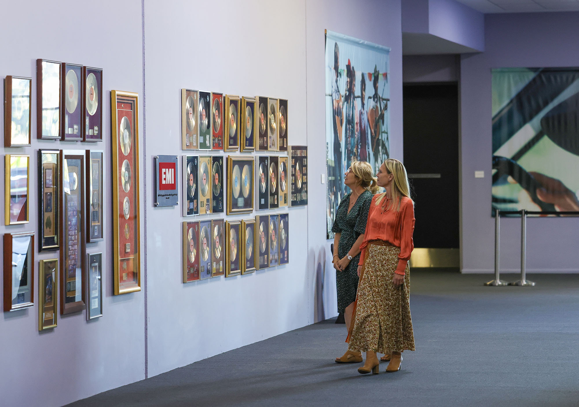 Two ladies browsing in the Golden Gallery in the museum at the Slim Dusty Centre.